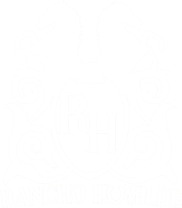 The Rancho Humilde logo depicting two horses back to back with the letters RH in the center and the words Rancho Humilde at the bottom of the monogram.